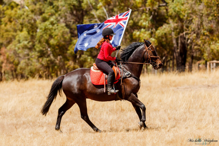 Miss B riding on Australia Day with Jackson whilst holding the Australian Flag