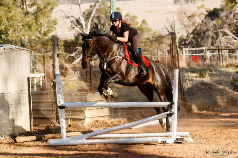 Miss B riding and jumping with Jackson