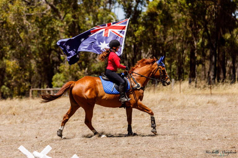 Miss B riding Flame on Australia Day with the Australian Flag