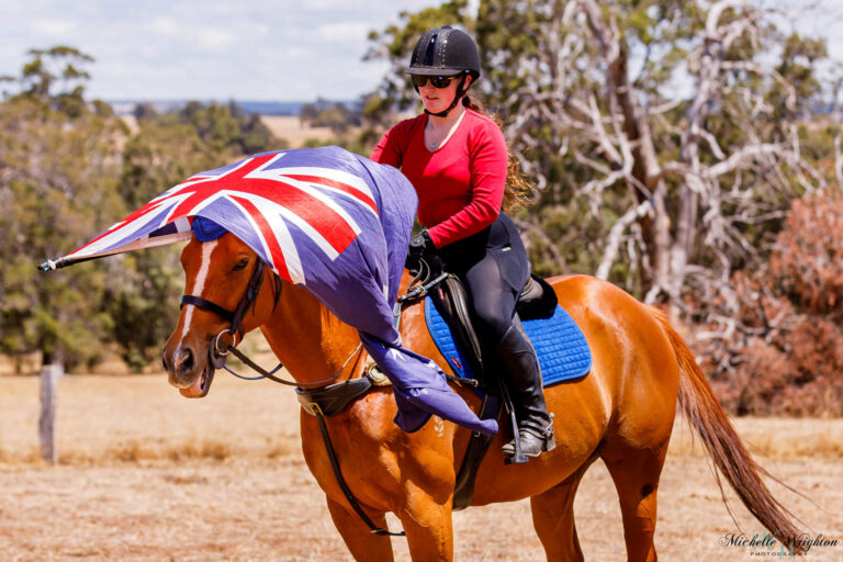 Miss B riding with Flame on Australia day holding the Australian flag