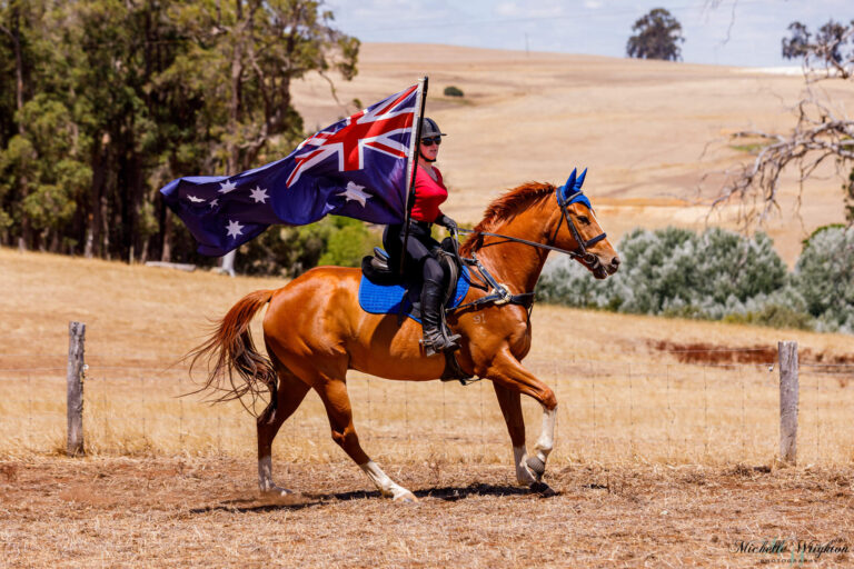 Miss B riding with Flame on Australia day holding the Australian flag