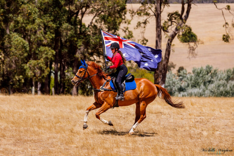 Miss B riding with Flame on Australia day holding the Australian flag