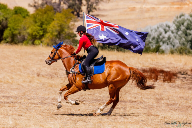 Miss B riding with Flame on Australia day holding the Australian flag