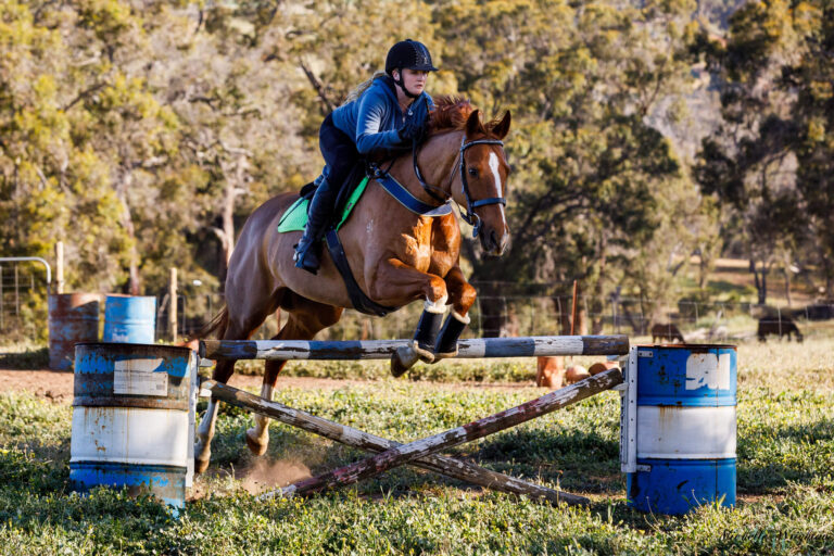 Miss B riding and jumping with Flame